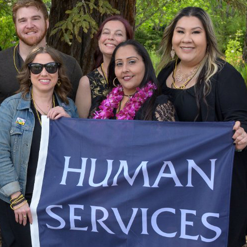 Group of Career Education Graduates holding a banner that reads Human Services