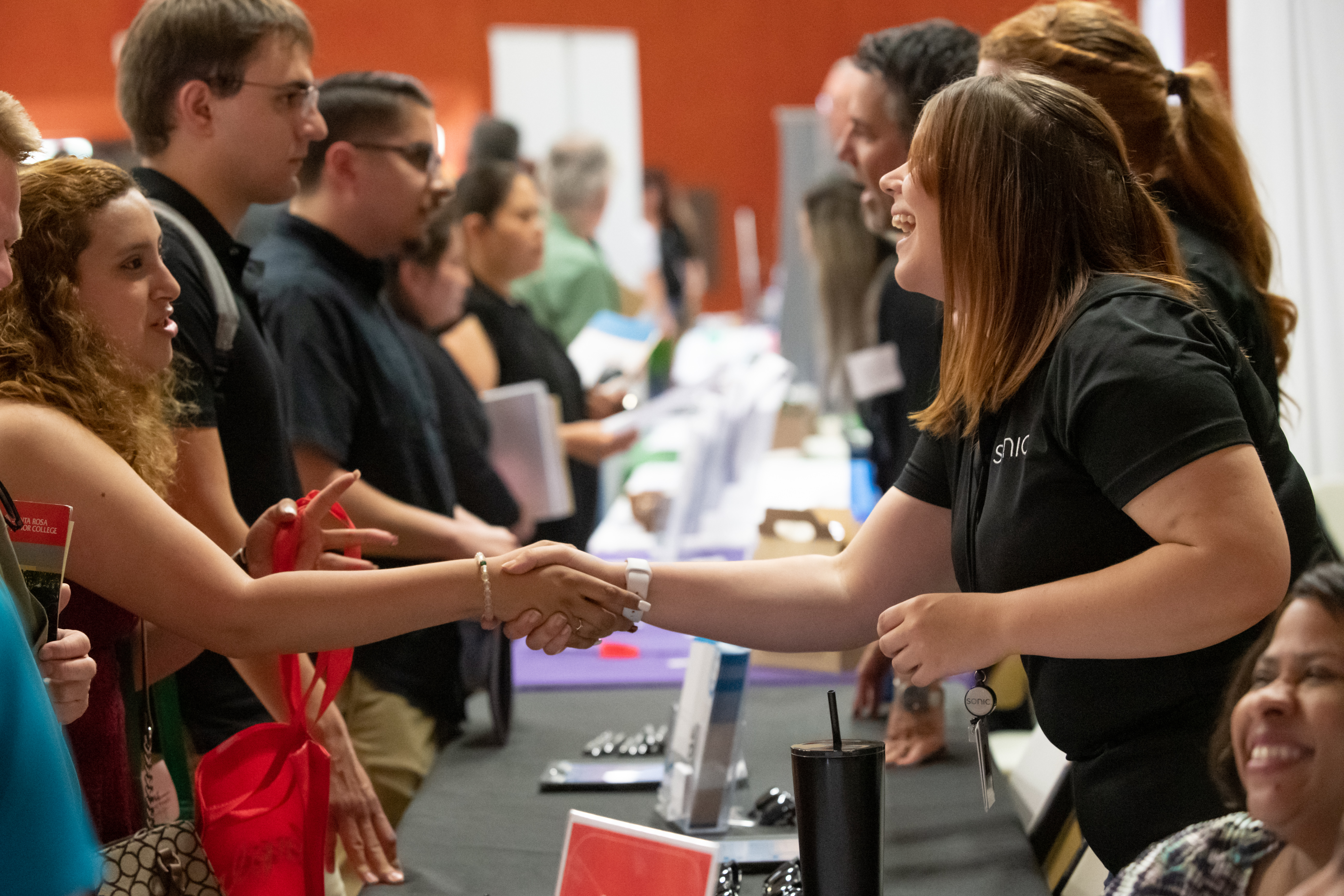 Employer shaking a student's hand at a career fair