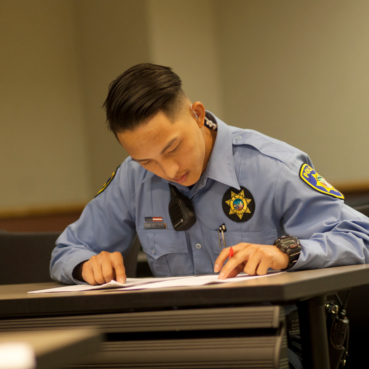 Public Safety Cadet sitting at a desk taking a test.